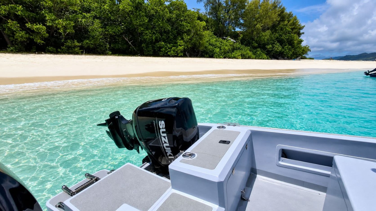 JJ's Charters boat at a Curieuse beach